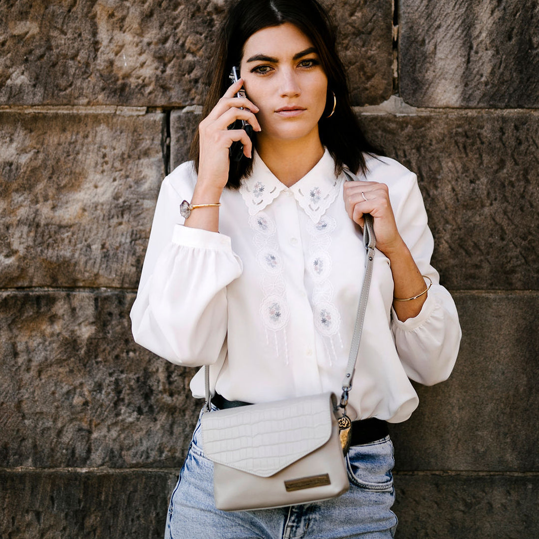 Mid sized grey leather ladies crossbody bag